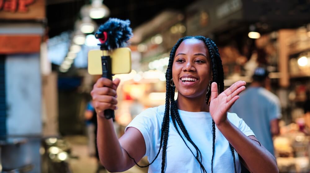 young woman streaming live to smartphone