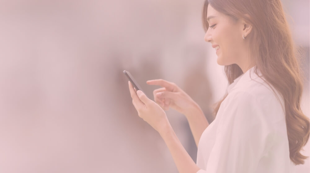 woman smiling looking at phone